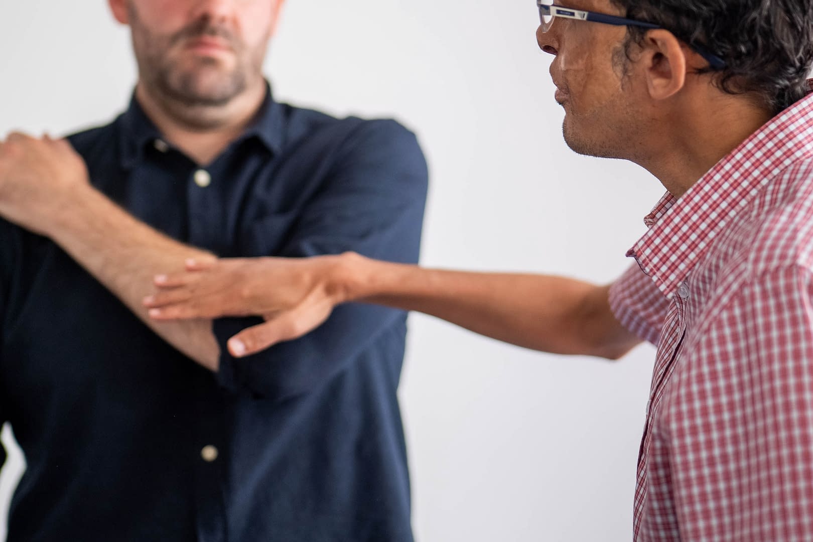 An FCP conducting manual therapy on a patient with shoulder pain.